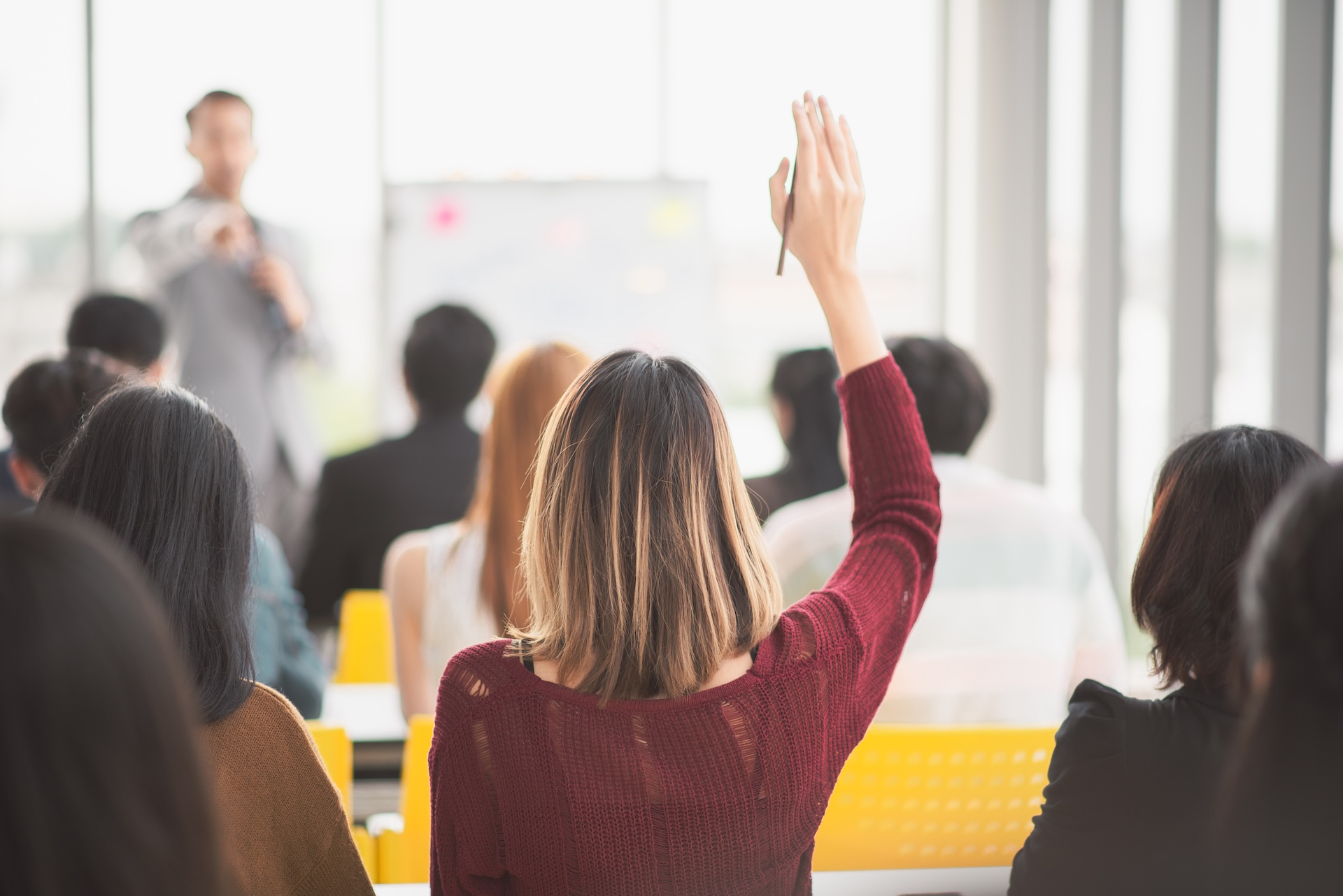 Educator raising hand during a training session.