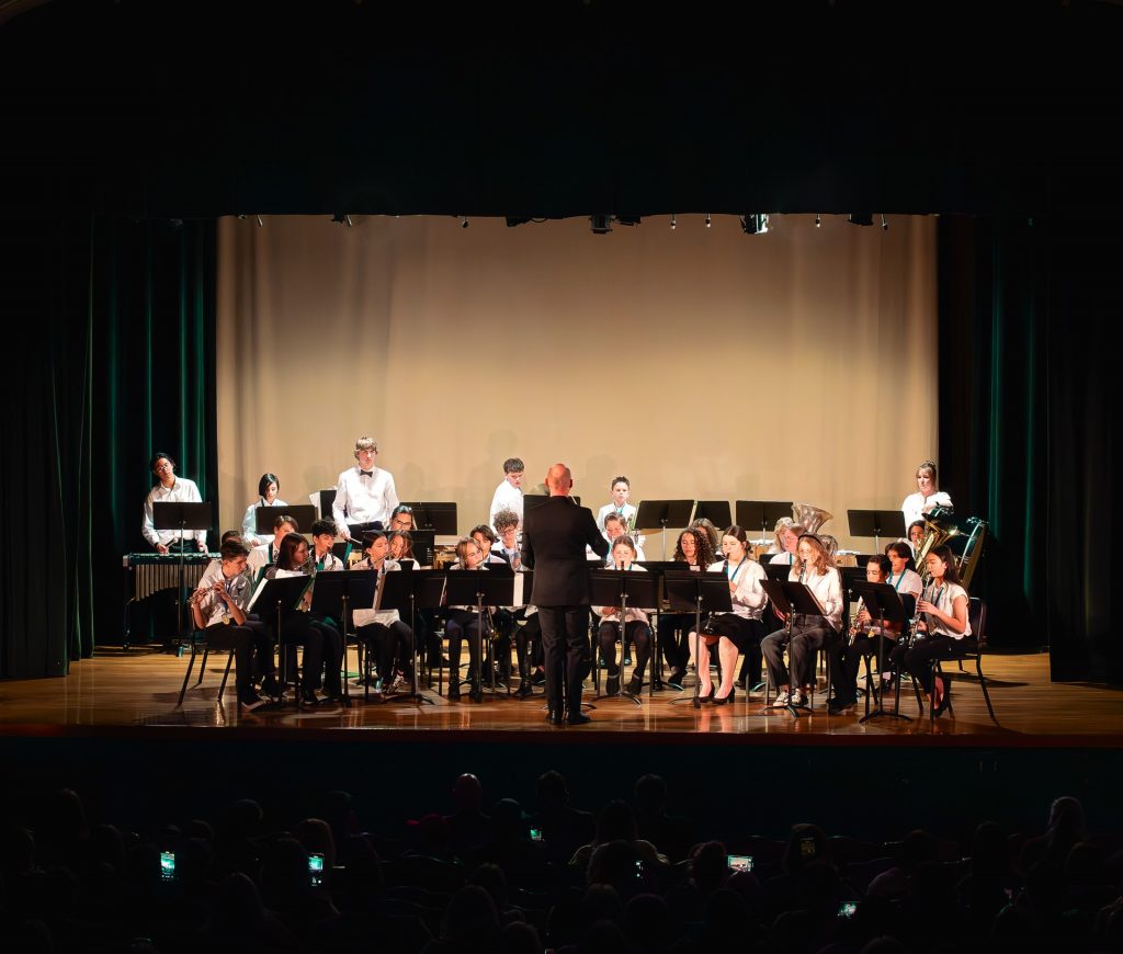 A wide shot of the Honor Band with conductor in the spotlight.