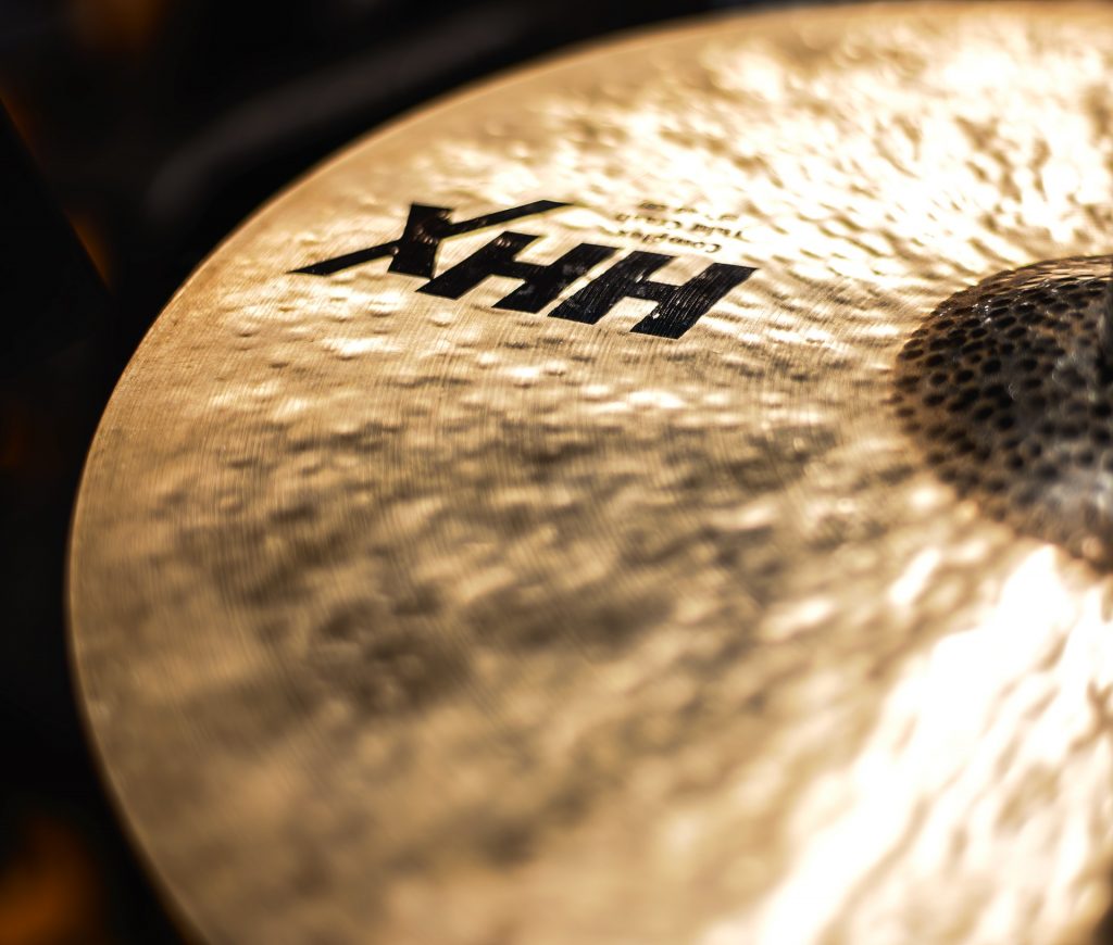 A textured cymbal reflecting warm golden light.