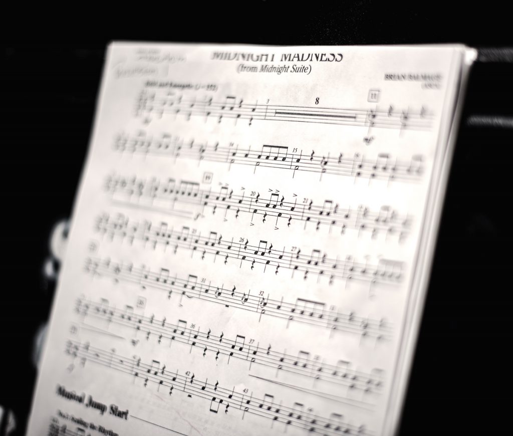 Sheet music for "Midnight Madness" displayed on a music stand.